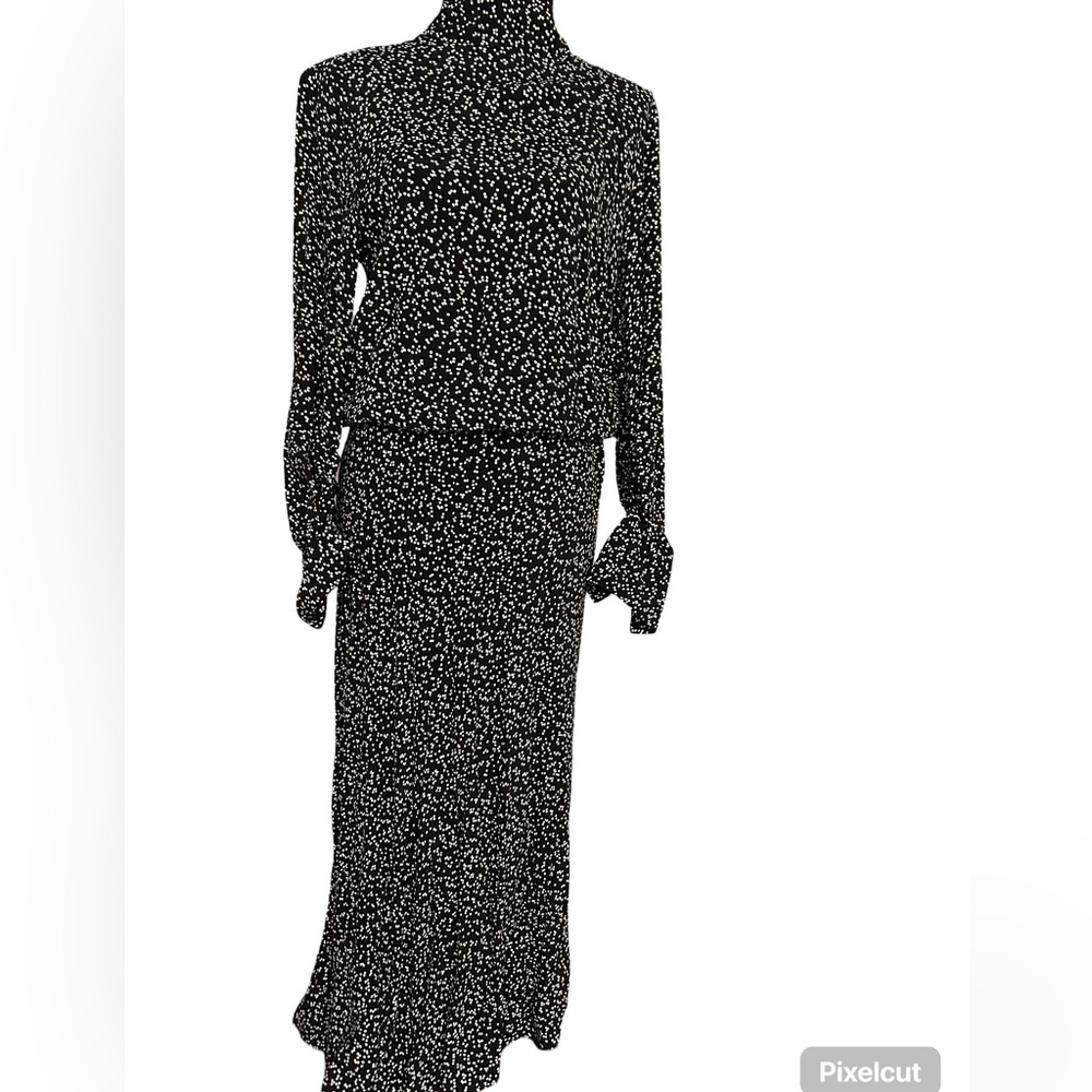 The Zara XS-sized black polka dot dress features a flattering, true-to-size fit.